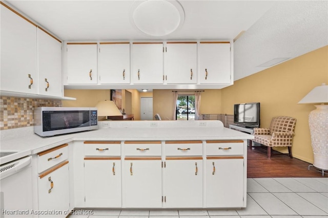 158 Parkview Cir, Lake Placid, FL 33852 - kitchen featuring stainless steel microwave, light countertops, tasteful backsplash, and white cabinets