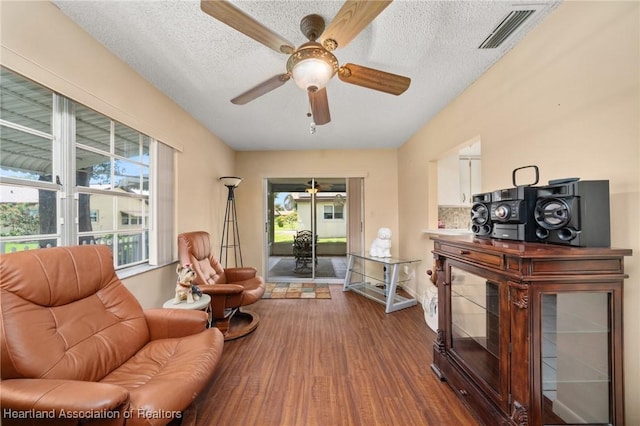 158 Parkview Cir, Lake Placid, FL 33852 - sitting room featuring dark wood-style flooring, healthy amount of natural light, a ceiling fan, and a textured ceiling