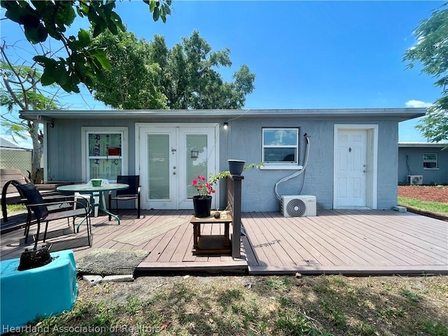 back of house with ac unit, french doors, and a wooden deck