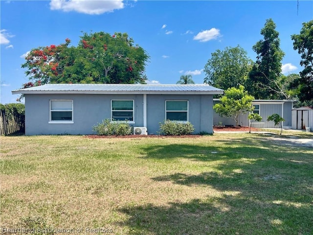 ranch-style home with a front lawn