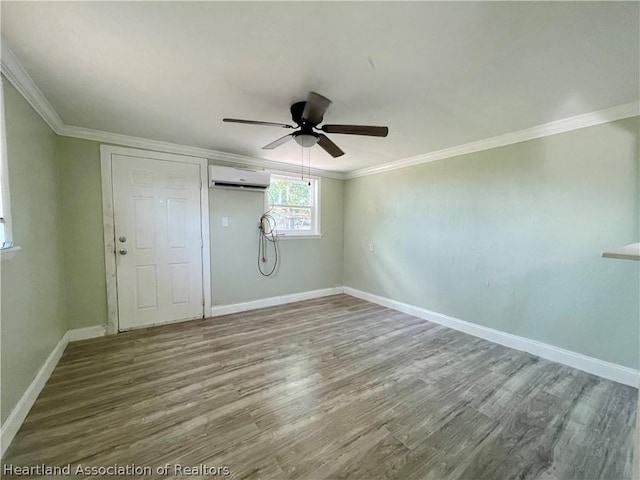 empty room with hardwood / wood-style flooring, ceiling fan, an AC wall unit, and crown molding