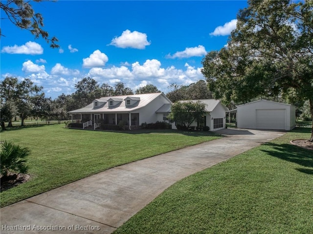 view of front facade featuring an outbuilding, a front yard, and a garage