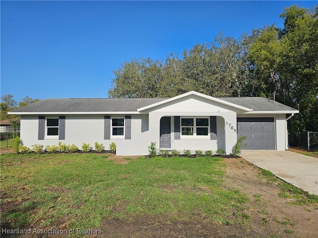 ranch-style home featuring a front lawn, a garage, stucco siding, and concrete driveway