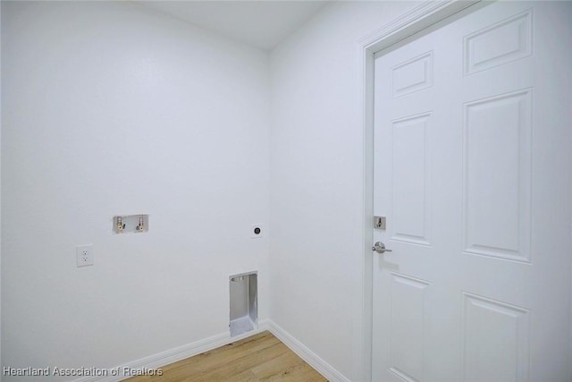 laundry room with electric dryer hookup, hookup for a washing machine, and light hardwood / wood-style floors