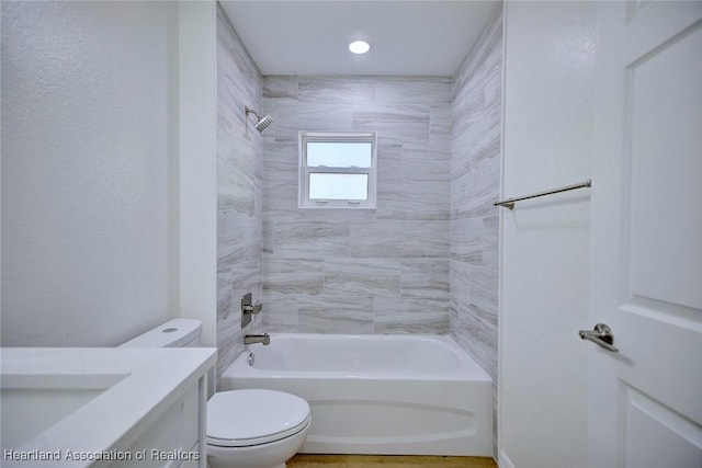 full bathroom featuring vanity, toilet, and tiled shower / bath