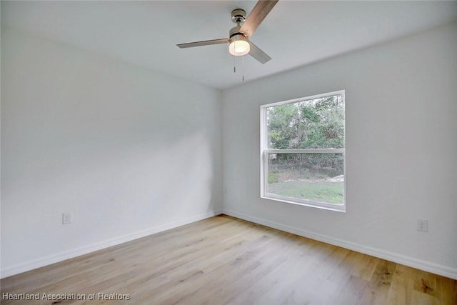 empty room with ceiling fan and light hardwood / wood-style floors