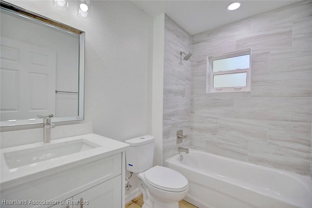 full bathroom featuring vanity, toilet, and tiled shower / bath