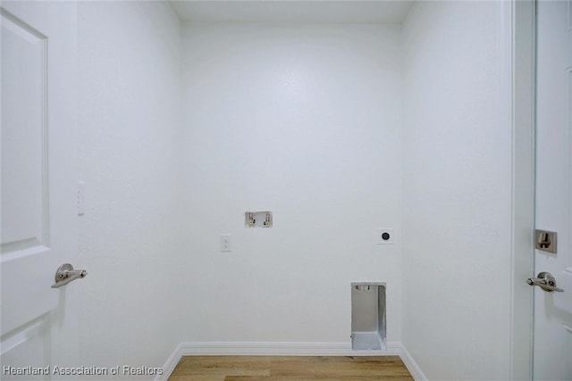 clothes washing area featuring hookup for a washing machine, light hardwood / wood-style floors, and hookup for an electric dryer