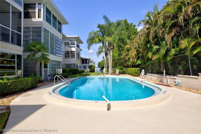 view of swimming pool with a patio area