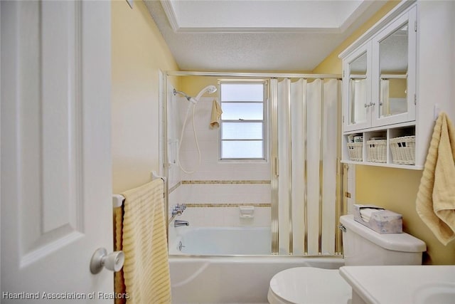 full bathroom featuring toilet, vanity, tiled shower / bath combo, and a textured ceiling