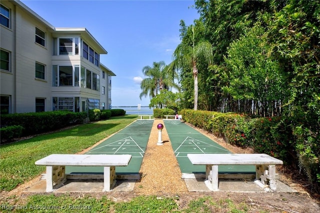 view of property's community with a yard