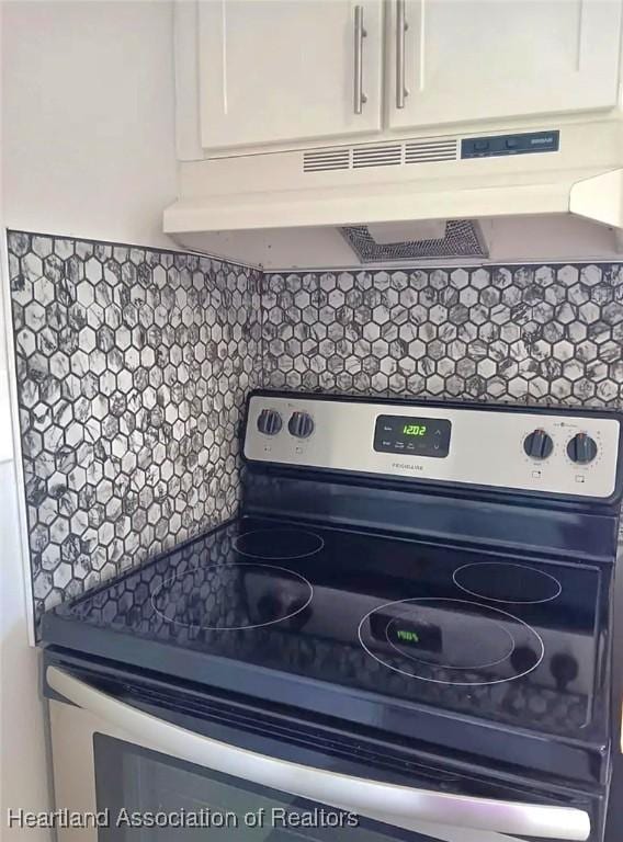 details featuring white cabinets, backsplash, and stainless steel electric range