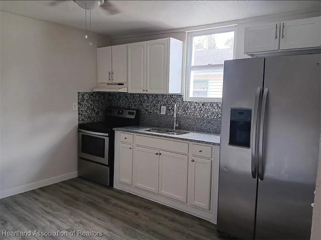 kitchen featuring sink, appliances with stainless steel finishes, white cabinetry, backsplash, and dark hardwood / wood-style flooring