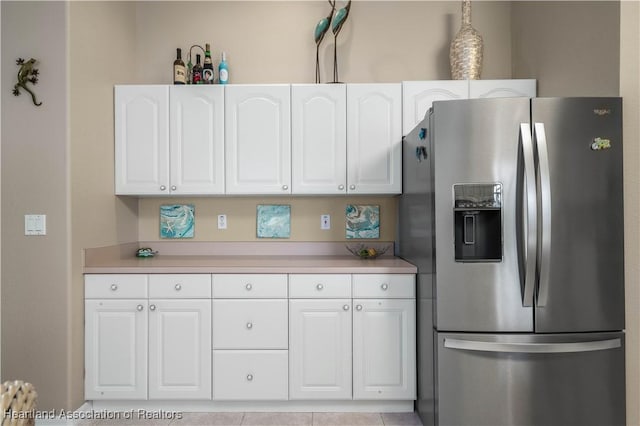 kitchen with decorative light fixtures, white cabinetry, and stainless steel fridge with ice dispenser