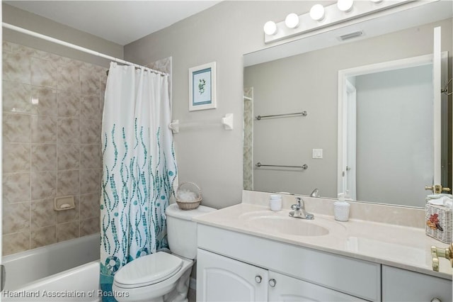 full bathroom featuring shower / bath combo, toilet, and vanity