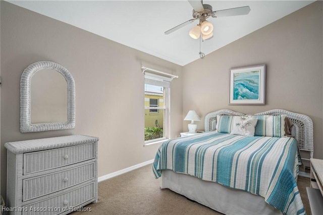 bedroom with ceiling fan, lofted ceiling, and carpet floors