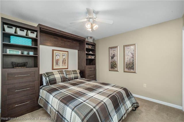 bedroom with ceiling fan and light colored carpet