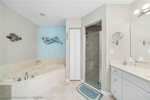 bathroom featuring tile patterned floors, vanity, and plus walk in shower