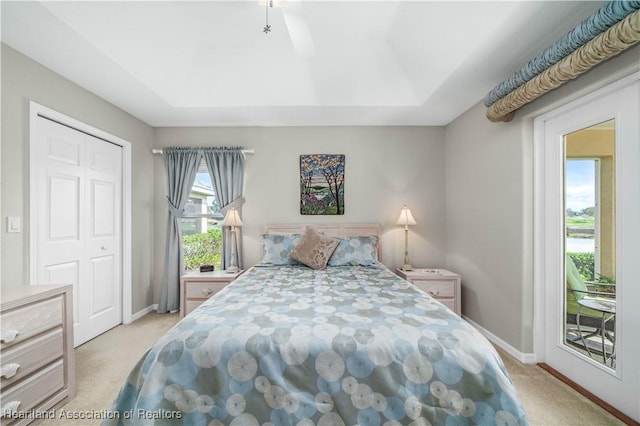 carpeted bedroom featuring ceiling fan, a closet, and access to outside