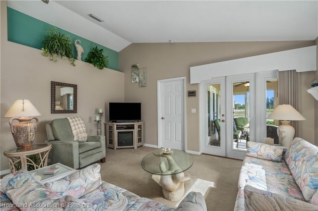 living room featuring light colored carpet, vaulted ceiling, and french doors