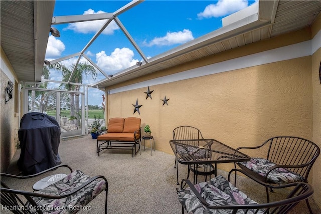 view of patio / terrace featuring glass enclosure and grilling area