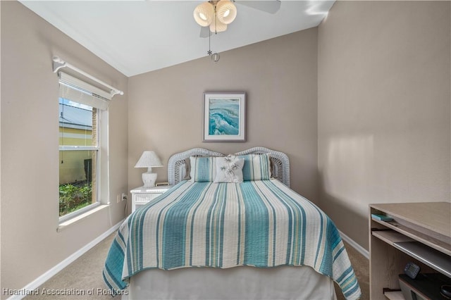 carpeted bedroom with ceiling fan and lofted ceiling