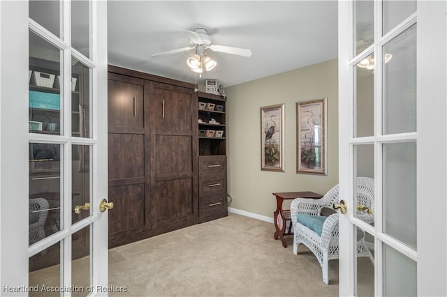 sitting room with ceiling fan and light carpet