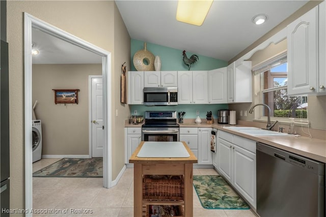 kitchen featuring sink, white cabinets, washer / dryer, and stainless steel appliances