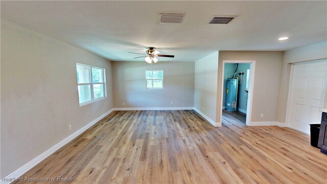 129 Badger Loop, Ona, FL 33865 - empty room featuring electric water heater, a ceiling fan, and light wood-style floors