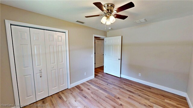 129 Badger Loop, Ona, FL 33865 - unfurnished bedroom featuring light wood-style floors, a closet, and a ceiling fan