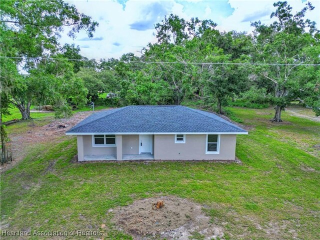 129 Badger Loop, Ona, FL 33865 - single story home featuring a front yard, stucco siding, and a patio area