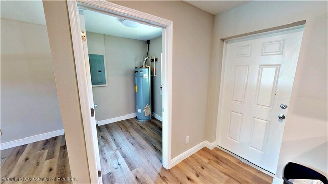 129 Badger Loop, Ona, FL 33865 - laundry area with water heater, electric panel, and light wood-style flooring