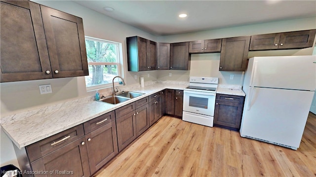 129 Badger Loop, Ona, FL 33865 - kitchen with white appliances, light wood finished floors, dark brown cabinetry, light countertops, and recessed lighting