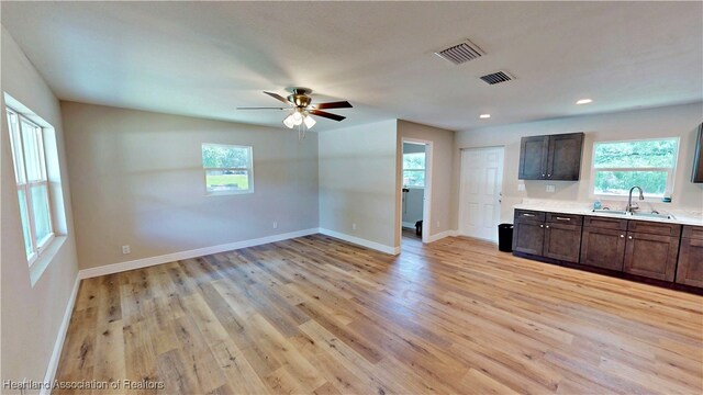 129 Badger Loop, Ona, FL 33865 - kitchen featuring light wood-type flooring, healthy amount of natural light, light countertops, and recessed lighting