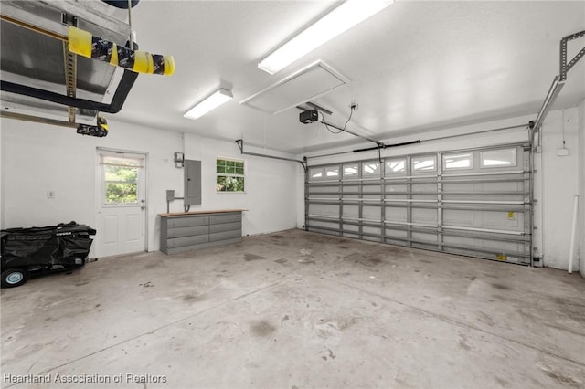 garage featuring a garage door opener and electric panel
