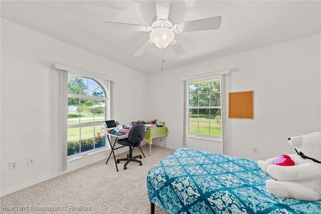 bedroom with ceiling fan, baseboards, and carpet