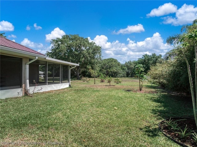 view of yard featuring a sunroom