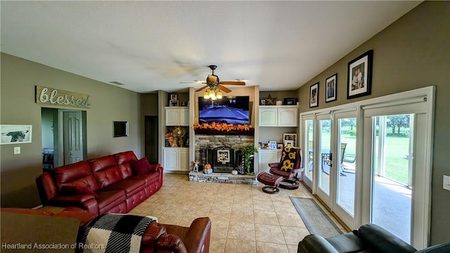 1779 State Road 62nd Rd, Bowling Green, FL 33834 - living area with light tile patterned floors, a fireplace, a ceiling fan, and visible vents