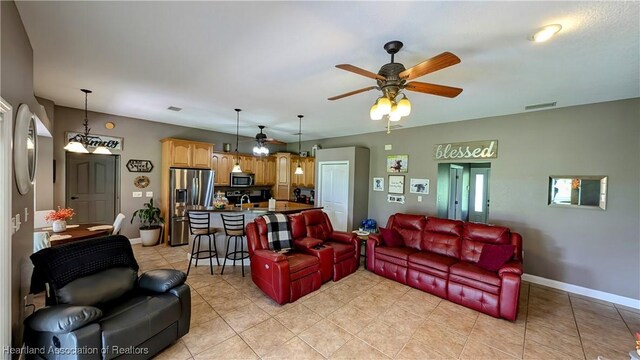 1779 State Road 62nd Rd, Bowling Green, FL 33834 - living area with light tile patterned floors, ceiling fan, visible vents, and baseboards