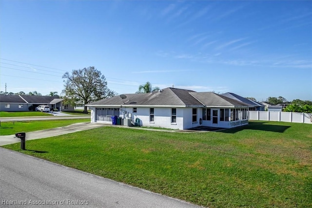 ranch-style home featuring a garage and a front lawn