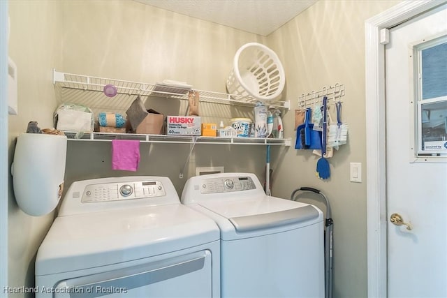 clothes washing area featuring washer and clothes dryer