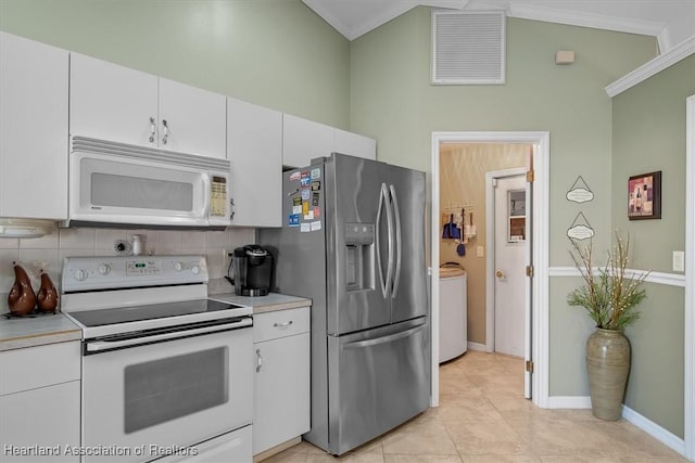 kitchen featuring white cabinetry, crown molding, white appliances, washer / clothes dryer, and decorative backsplash