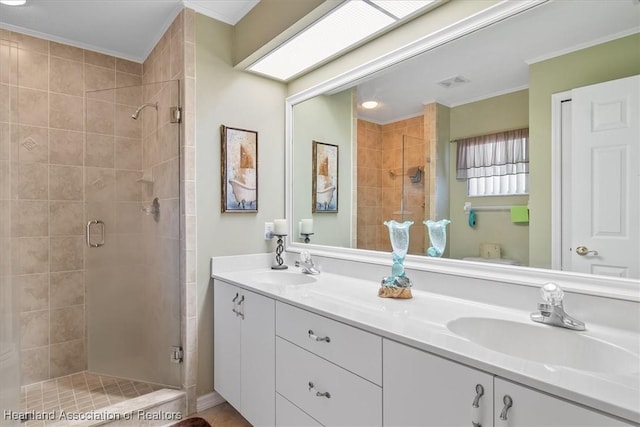 bathroom with vanity, crown molding, a skylight, and walk in shower