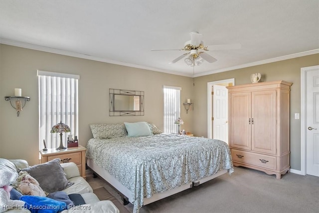 carpeted bedroom featuring crown molding and ceiling fan