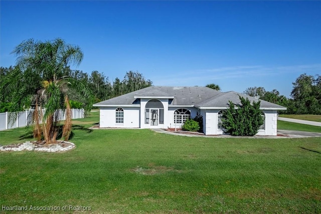 ranch-style home featuring a front yard