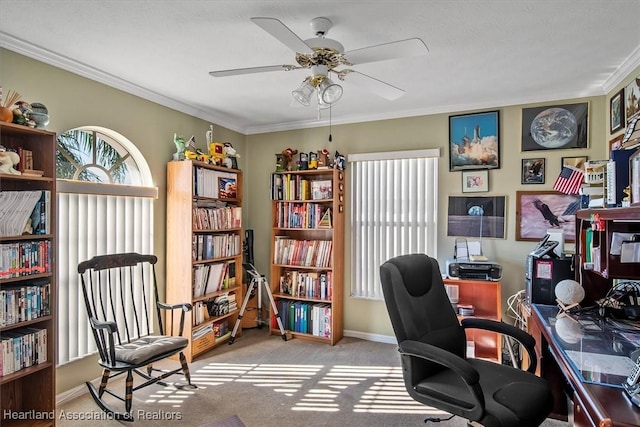 home office with crown molding, ceiling fan, and light carpet