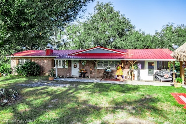 rear view of property with a lawn