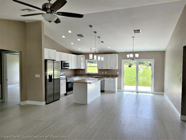 kitchen with a center island, stainless steel appliances, pendant lighting, white cabinets, and ceiling fan with notable chandelier