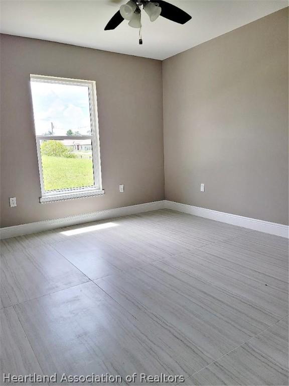 unfurnished room featuring ceiling fan