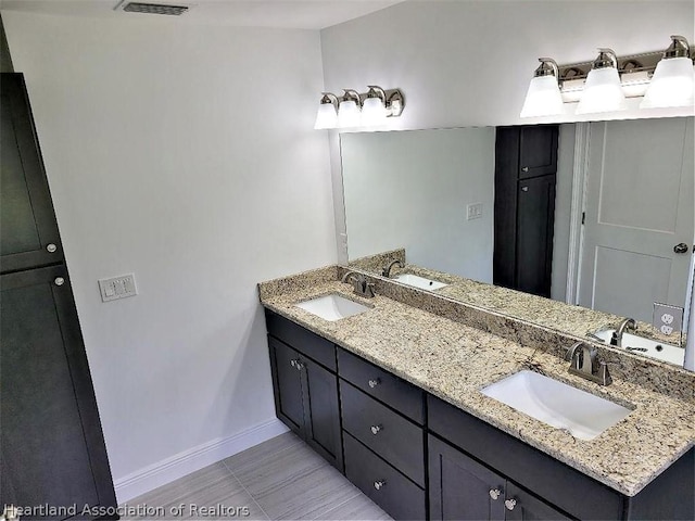 bathroom featuring tile patterned flooring and vanity